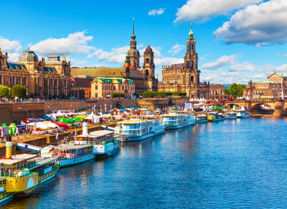 Colourful boats docked in the Elbe river alongside the city of Dresden, Germany.