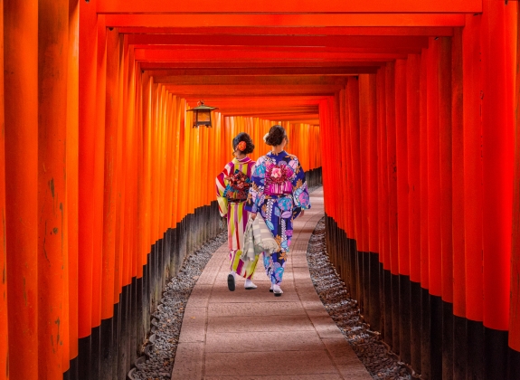 Women in traditional japanese kimonos walking at Fushimi Inari Shrine in Kyoto, Japan