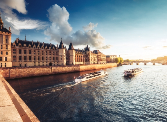 Dramatic sunset over river Seine and Conciergerie in Paris, France, with cruise boats and Pont Neuf. Colourful travel background. Romantic cityscape. Dramatic sunset over river Seine and Conciergerie in Paris, France, with cruise boats and Pont Neuf. Colourful travel background. Romantic cityscape.
