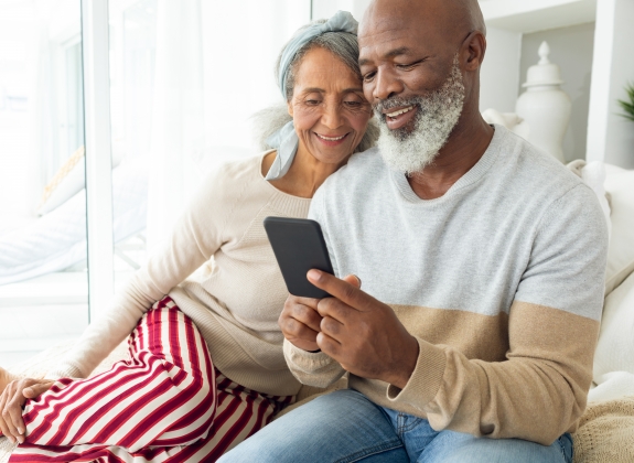Contact Railbookers happy retired couple looking at cell phone