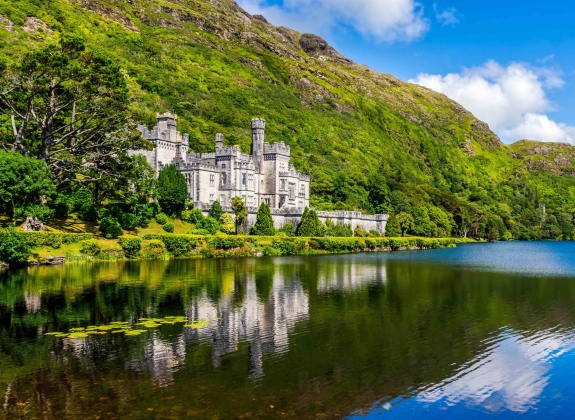 Kylemore Abbey, beautiful castle like abbey reflected in lake at the foot of a mountain. Benedictine monastery founded in 1920, in Connemara, Ireland