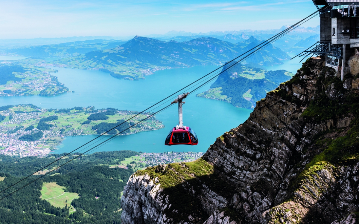 The summit of Mount Pilatus A Gondola reaches the top of the mountain with lake vista in the distance