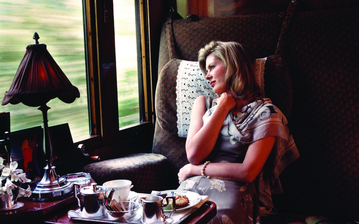 Onboard the Venice Simplon-Orient Express A lady relaxes in comfortable train seat