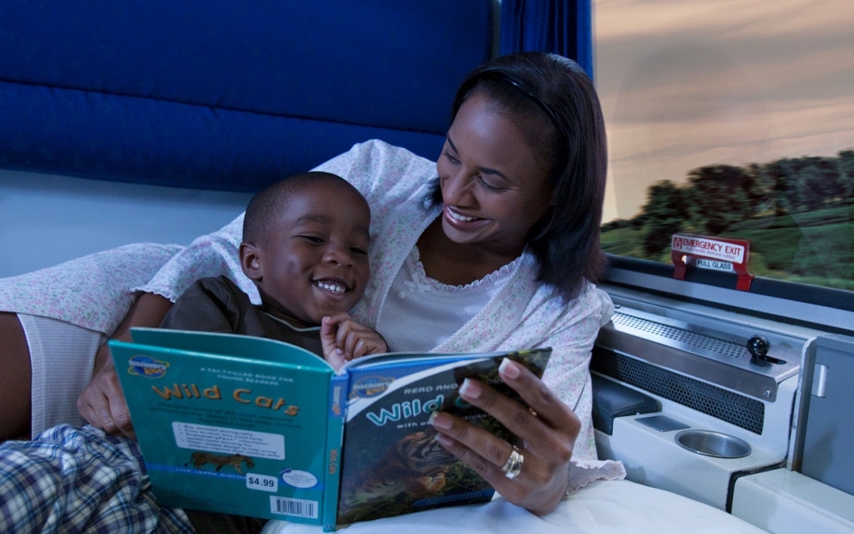 mom and child reading in Amtrak's family bedroom at night