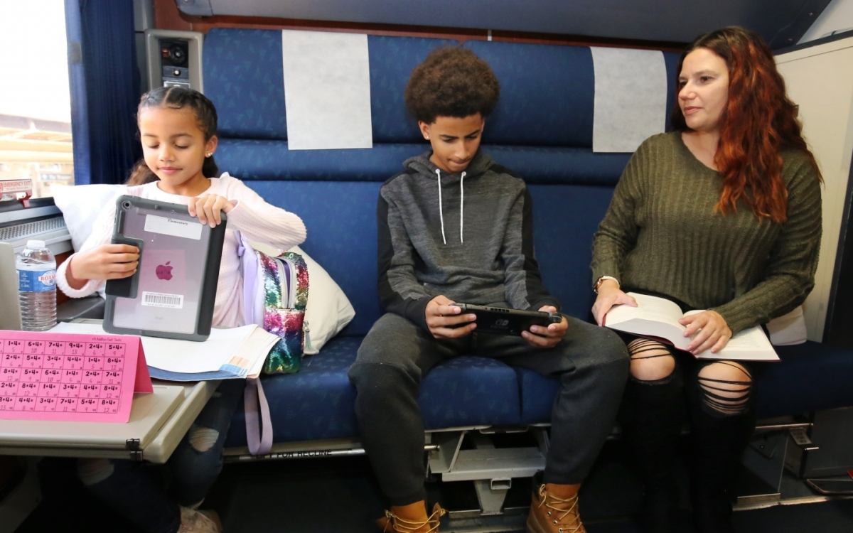 family relaxing in Amtrak's family bedroom