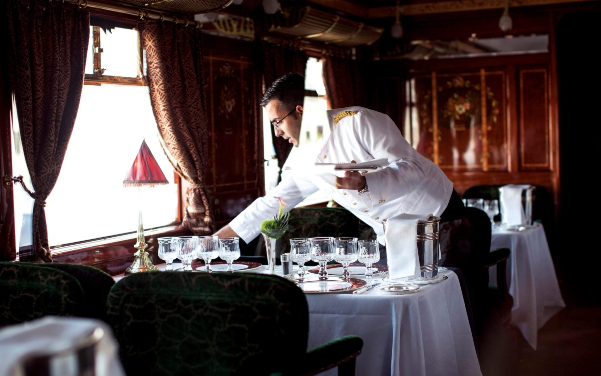 waiter setting tables in the Cote Dazur Restaurant onboard the Venice Simplon-Orient-Express waiter setting tables in the Cote Dazur Restaurant onboard the Venice Simplon-Orient-Express