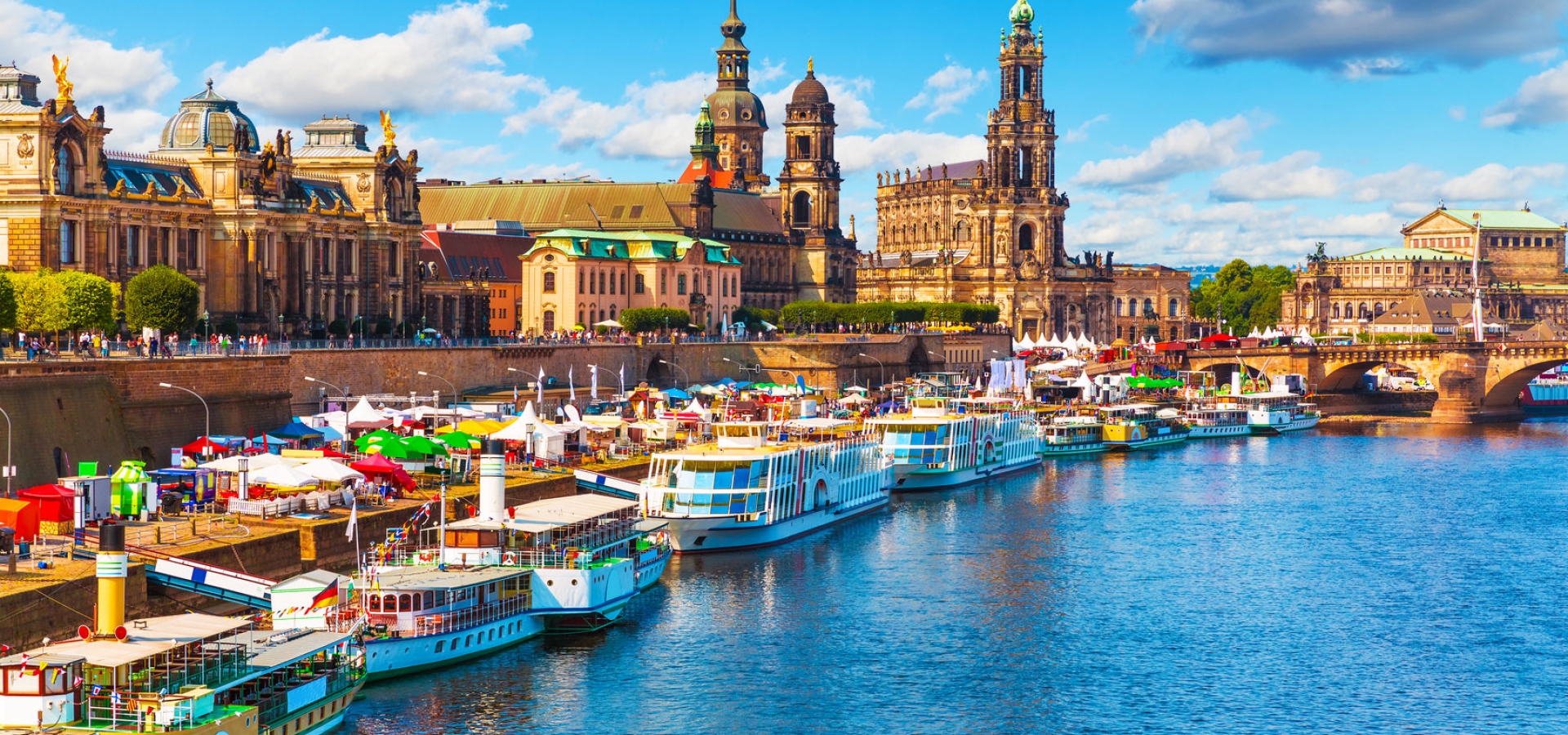 Dresden-Old-Town-Summer Colourful boats docked in the Elbe river alongside the city of Dresden, Germany.