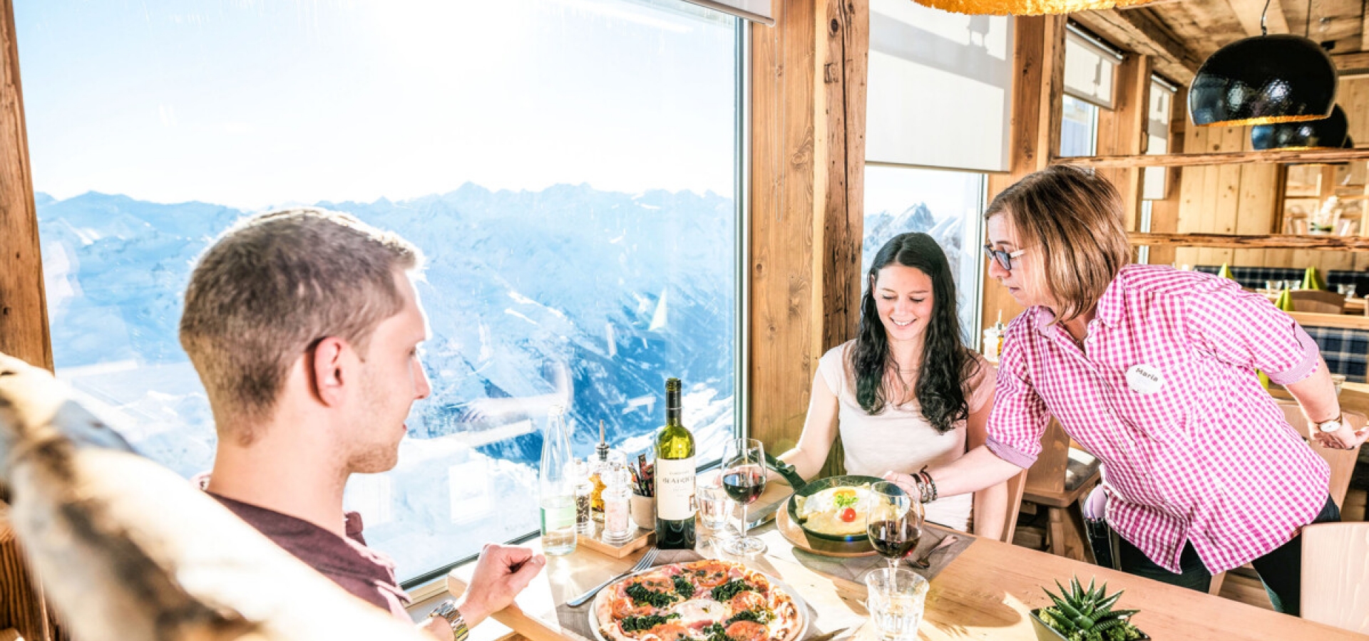 A couple are served a meal in a panoramic restaurant