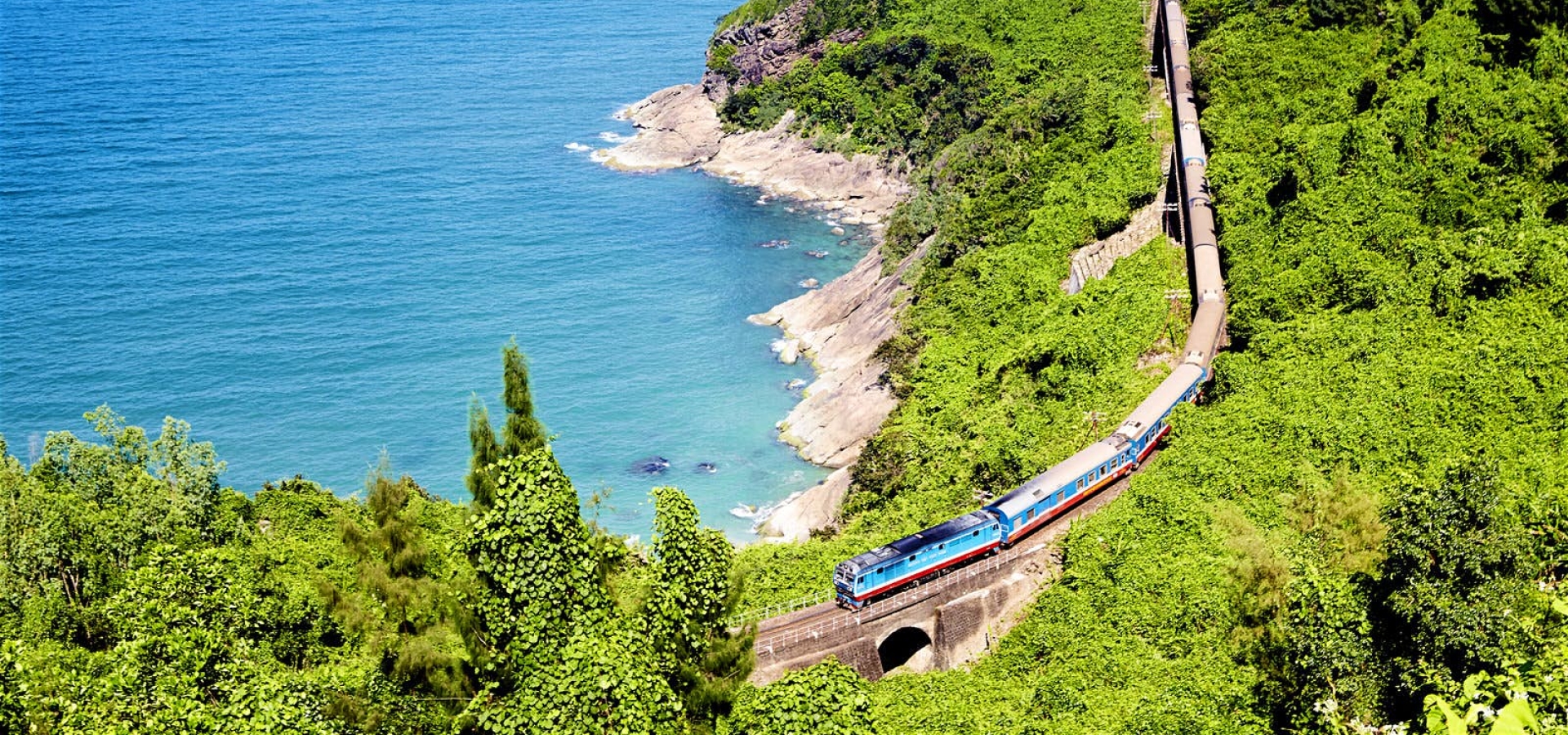 A train travels alongside the Vietnamese Coastline
