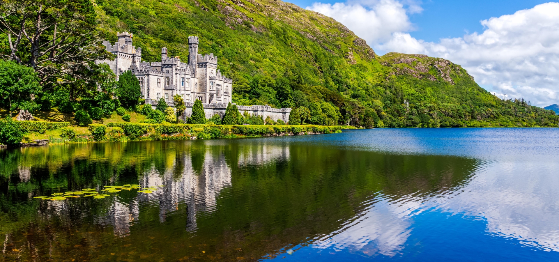 Kylemore Abbey, beautiful castle like abbey reflected in lake at the foot of a mountain. Benedictine monastery founded in 1920, in Connemara, Ireland
