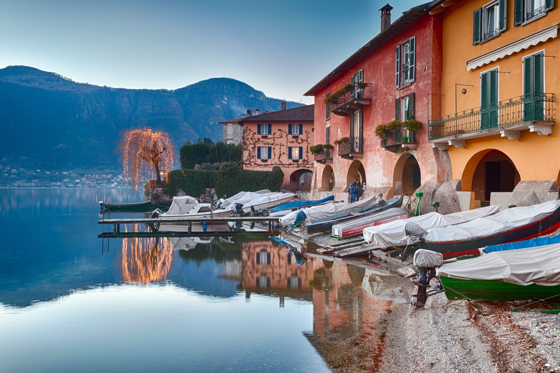 boats on calm waters of lake como, italy