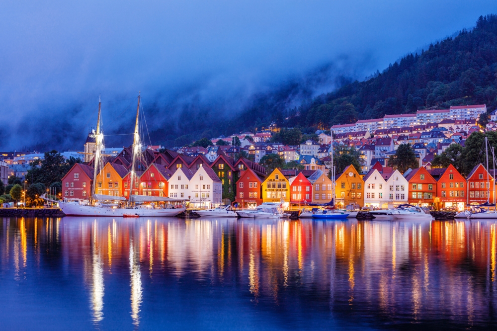 Bergen street at night with boats in Norway Special Offers with Railbookers