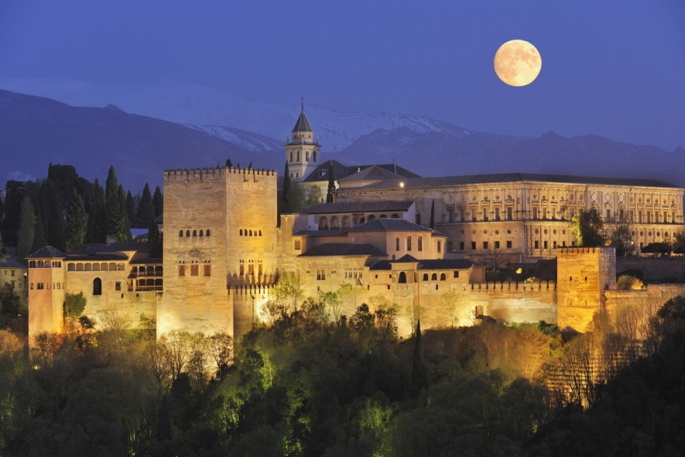 The Alhambra fortress under a full moon.