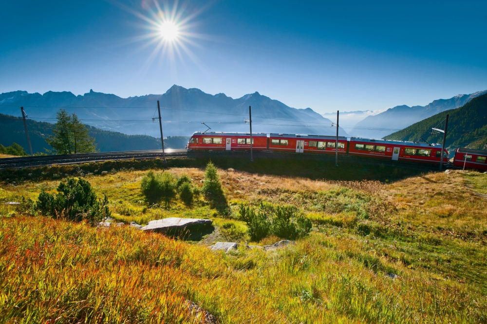 The Bernina Express A train travels up a mountain through the Alps