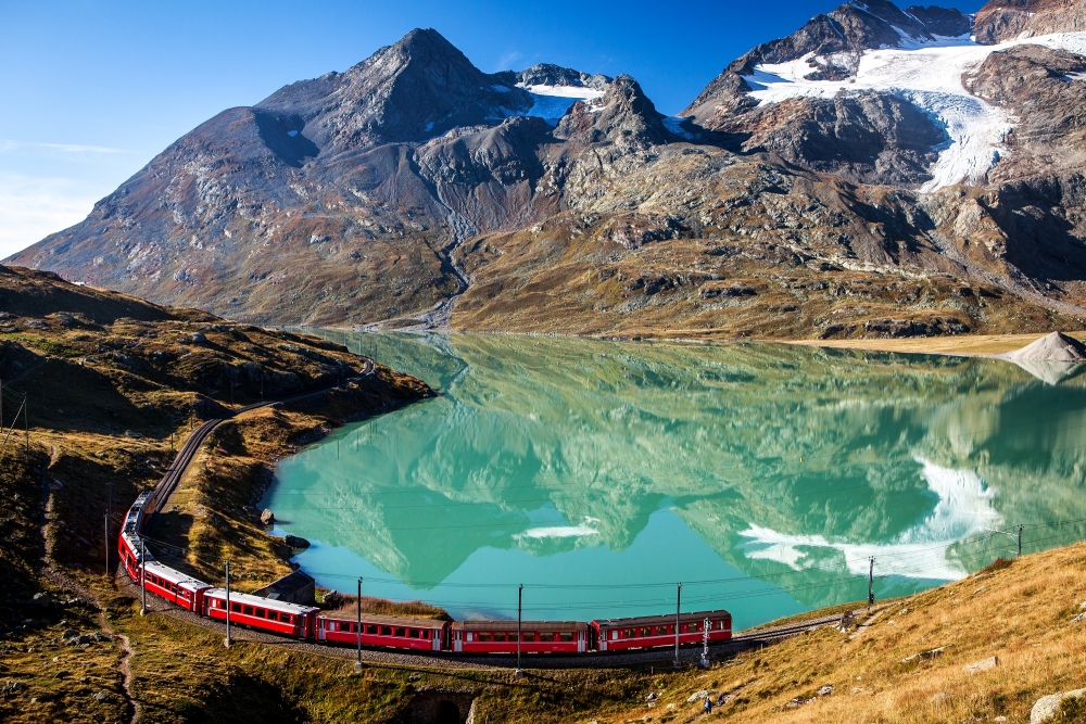 train in the scenic swiss alps around bernina and moteratsch glacier