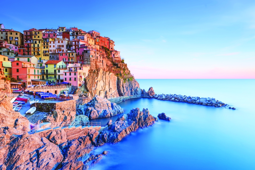 Manarola village, rocks and sea at sunset in Cinque Terre