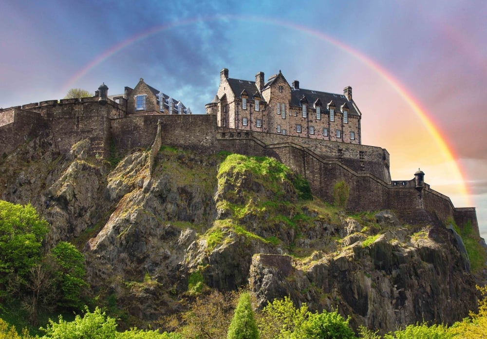 Scotland - Rainbow over Edinburgh Castle with green garden, UK