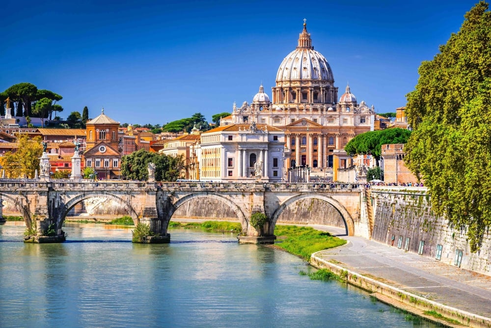 Rome, Italy. Vatican dome of Saint Peter Basilica and Sant'Angelo Bridge, over Tiber river.