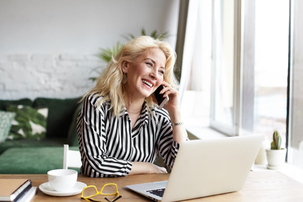 woman sitting at desk in front of open laptop